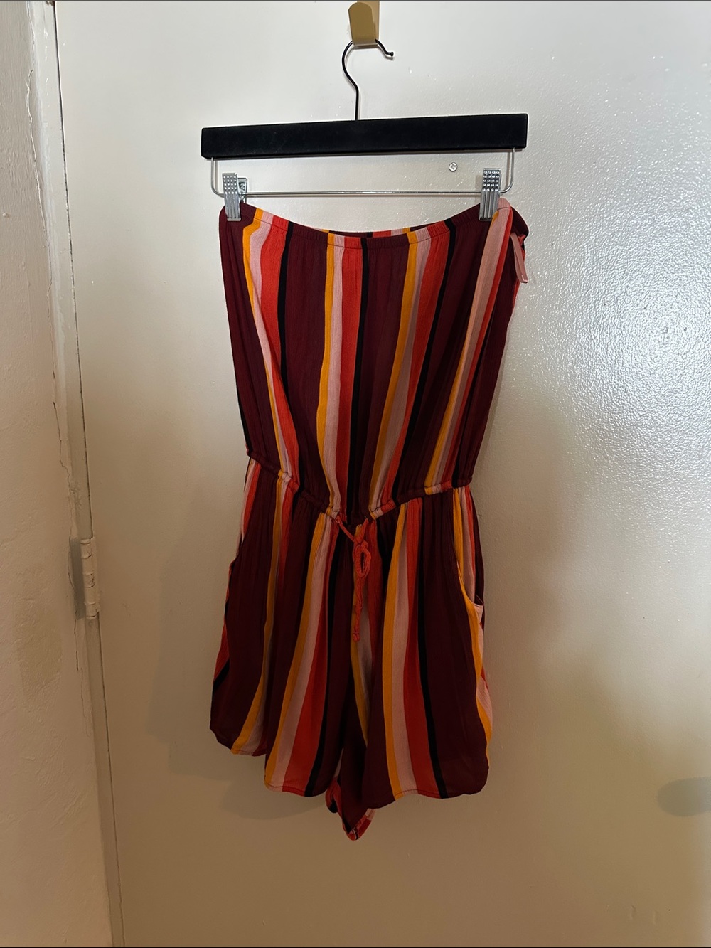 Hollister Co. orange, red, and white vertical striped romper in a L